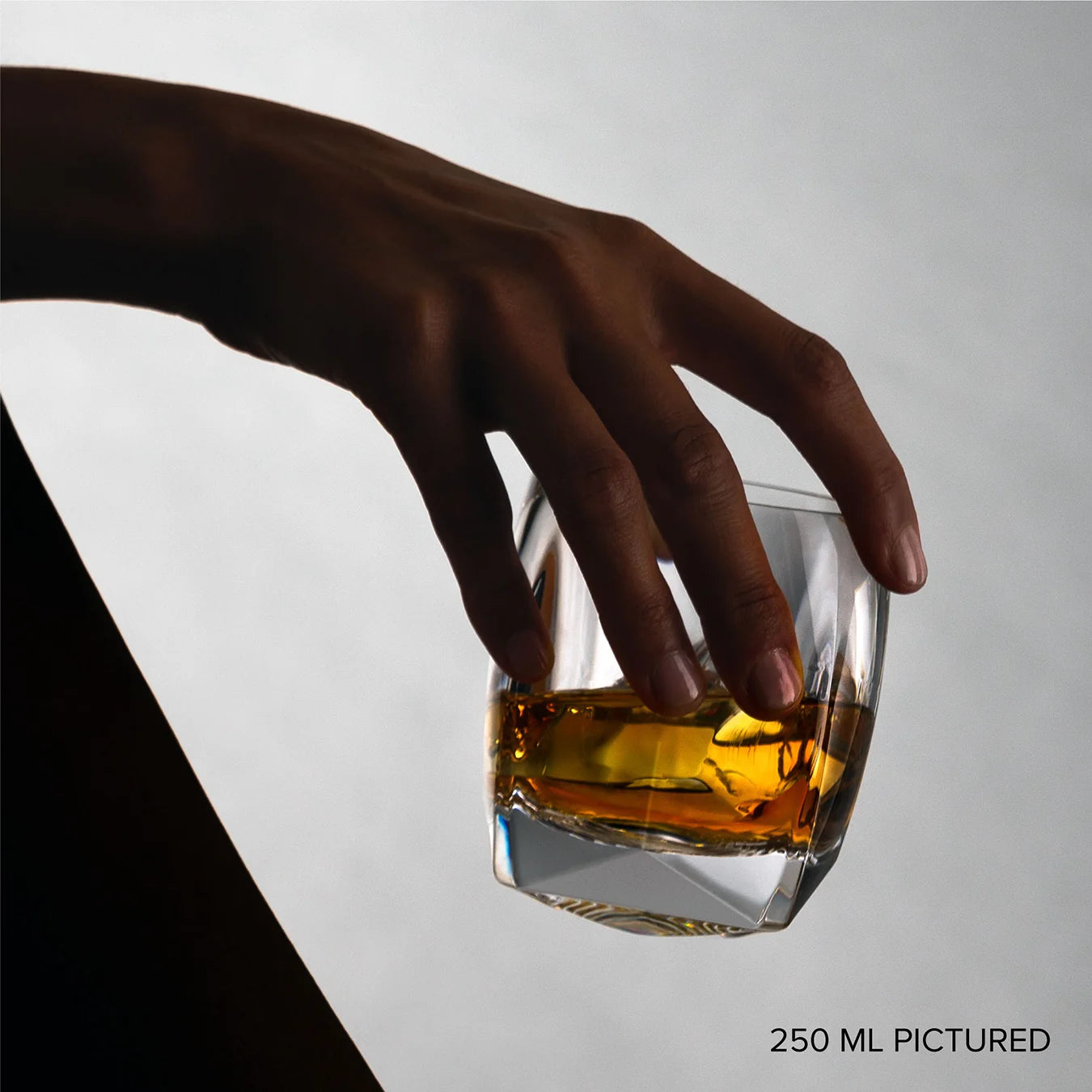 Clear Rauk Heavy Tumbler shown angled with visible weight and crystal clarity, ideal for bourbon, scotch, or cocktails